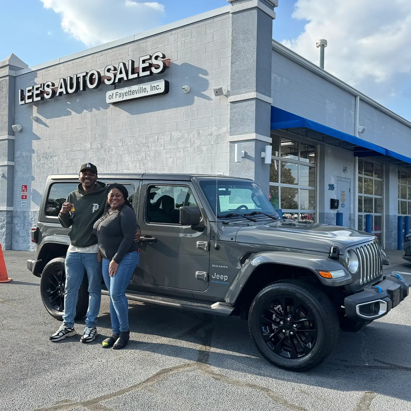 Happy Lee's Auto Sales customer with their vehicle