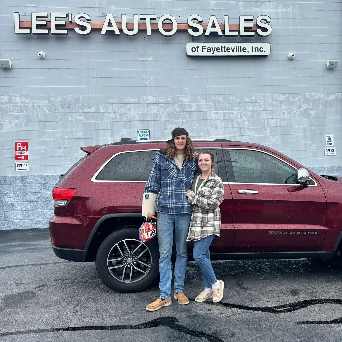 Happy Lee's Auto Sales customers with their vehicle